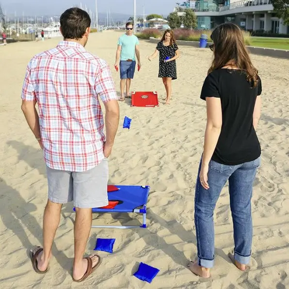 People playing cornhole on the beach